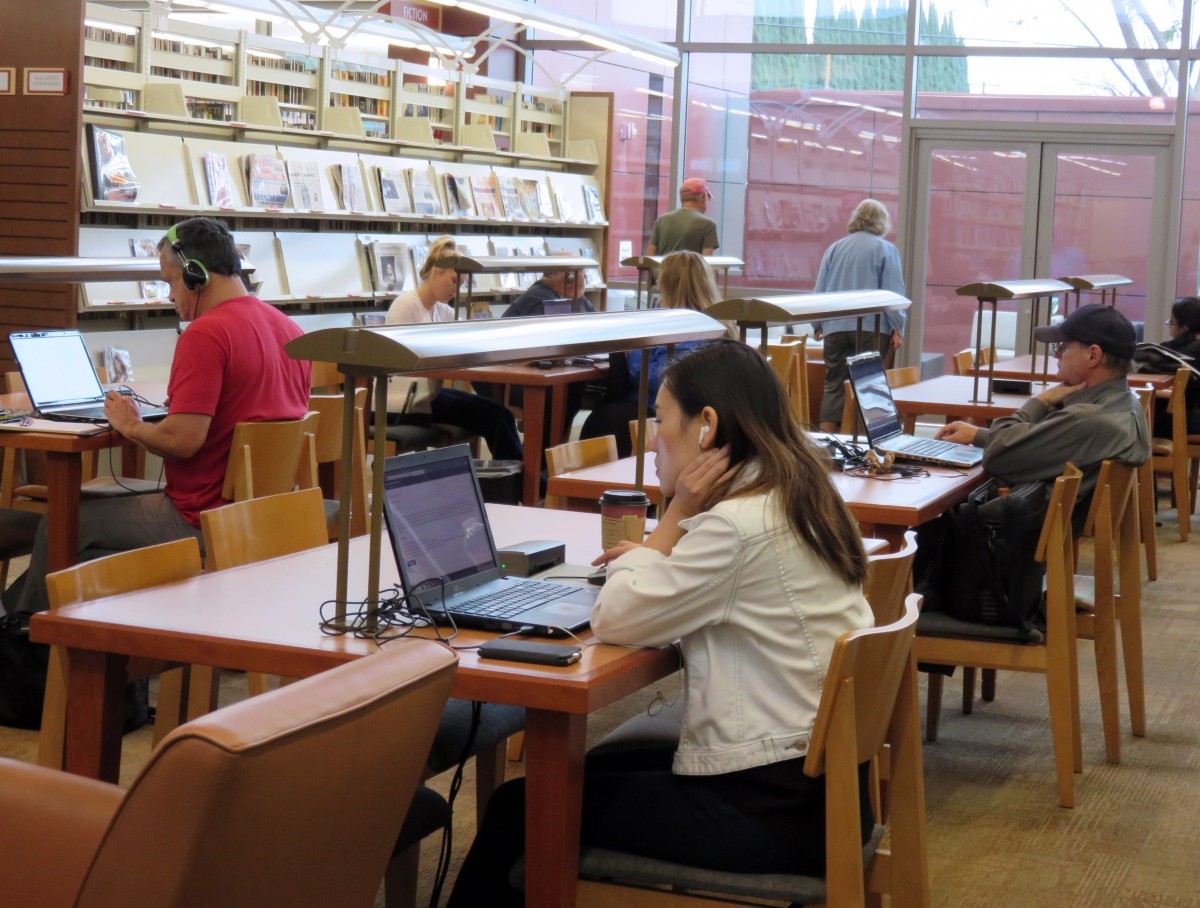 Students studying at desks in a library