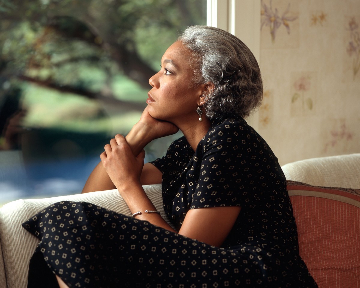 Woman seated beside a window